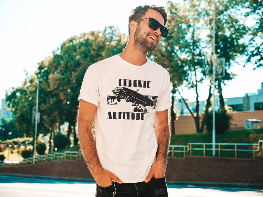 Bearded man laughing outdoors, wearing a Chronic Altitude tee